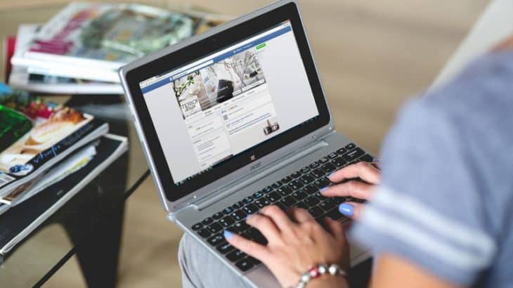 woman using social media on a laptop