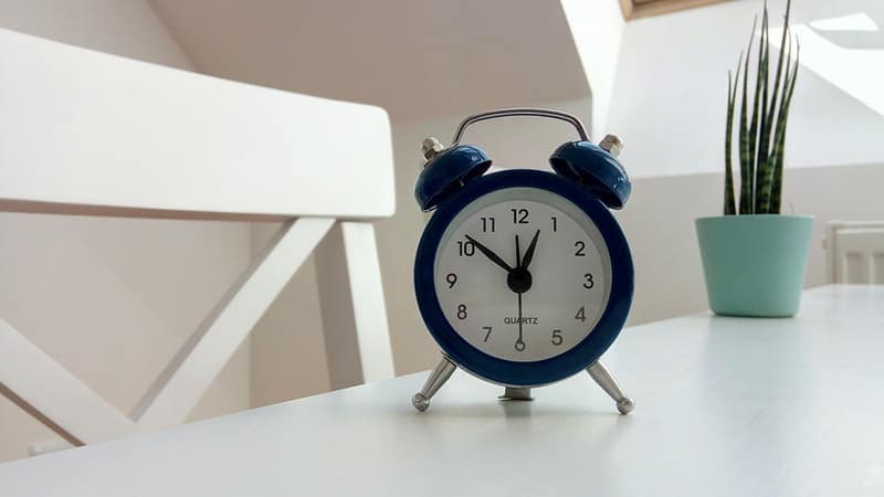 a blue clock on a white table