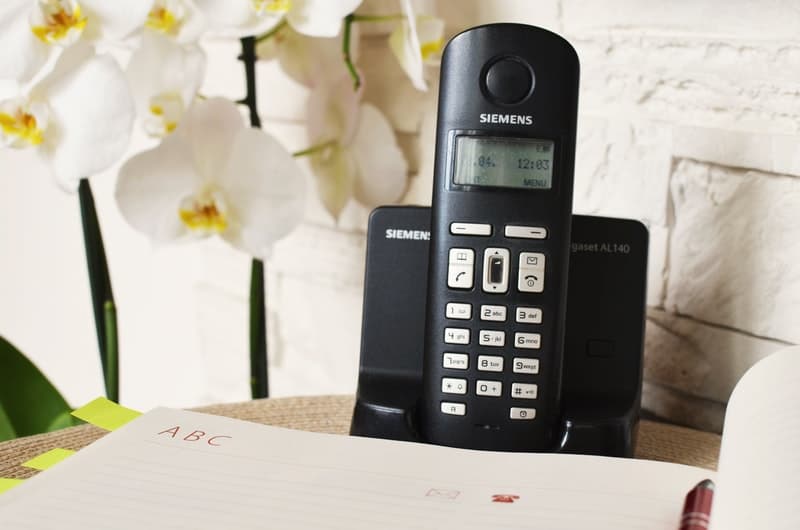telephone on a desk with flowers
