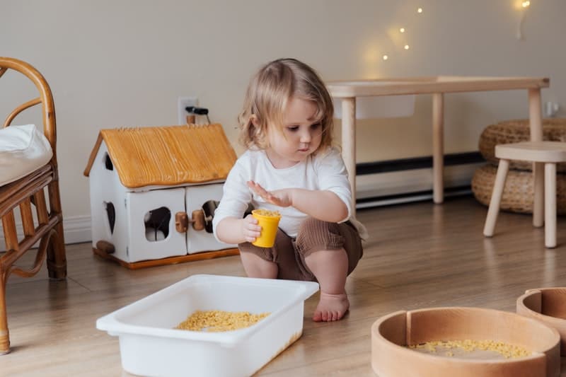 child playing with a sensory bin