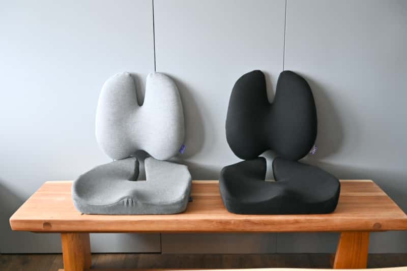 two lumbar support pillows on a brown bench