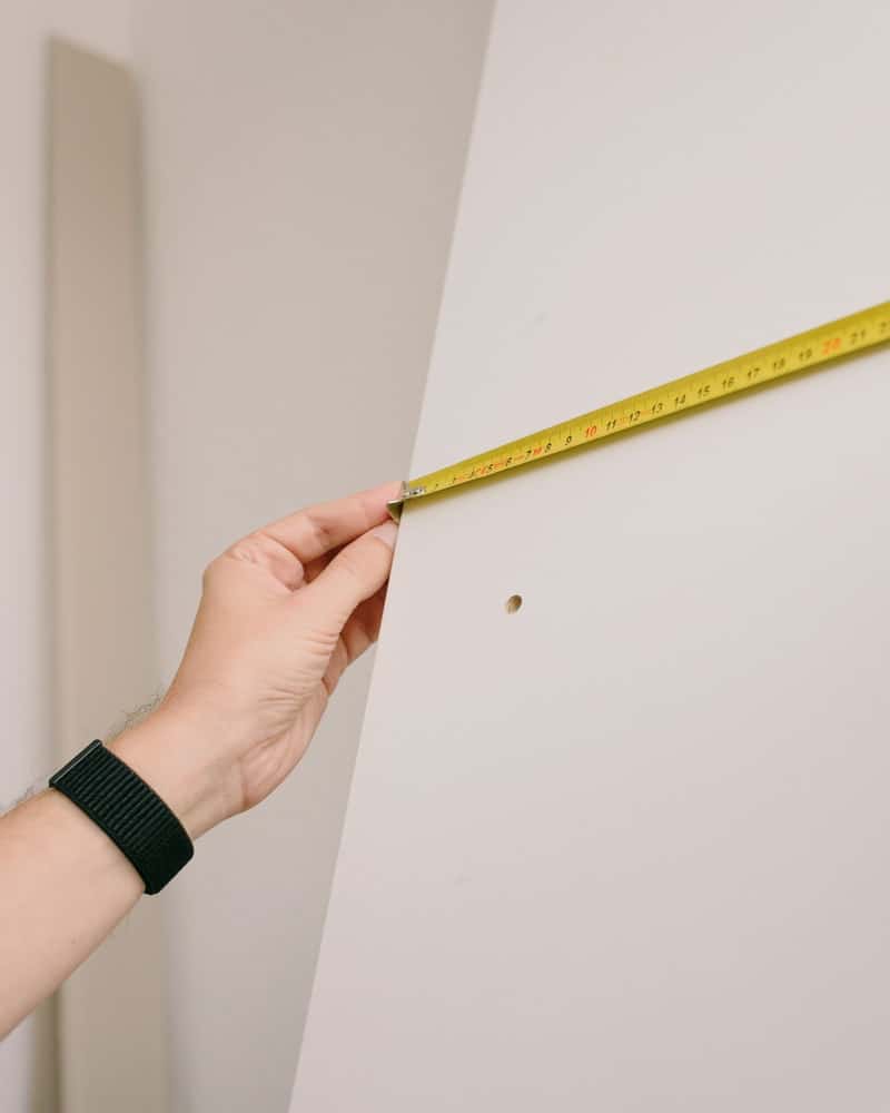 woman measuring walls with ruler