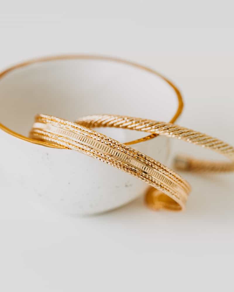 gold earrings in a white bowl