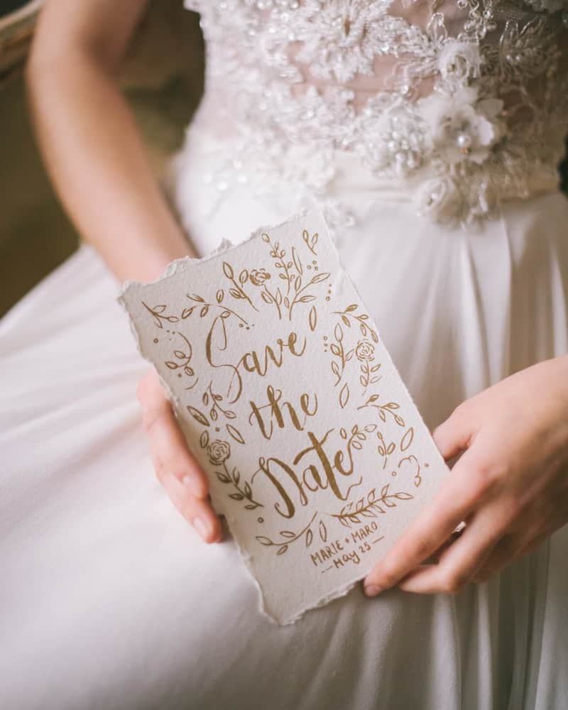 a bride holding a wedding invitation