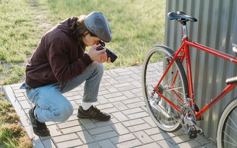 a man taking a photograph of a bicycle