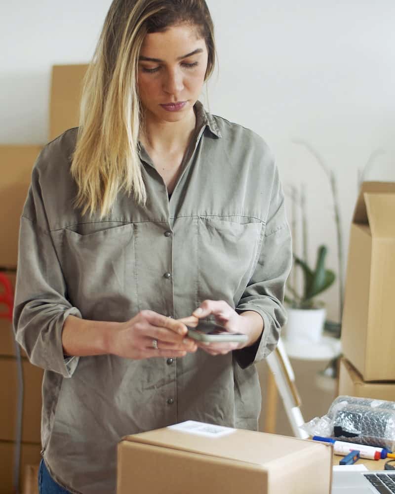 a woman packing a box for shipment