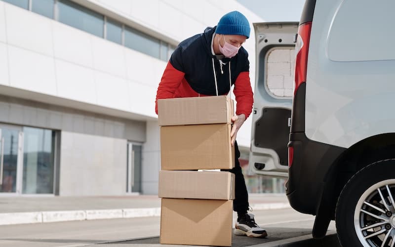 man loading boxes in van